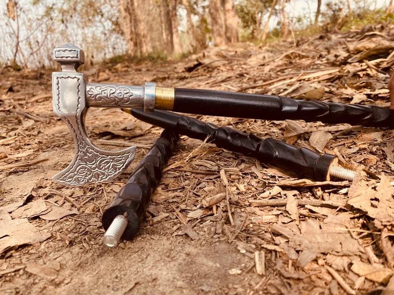 Antique walking cane with removable brass ring, axe-shaped handle, and a sturdy wooden shaft, offering a unique vintage look