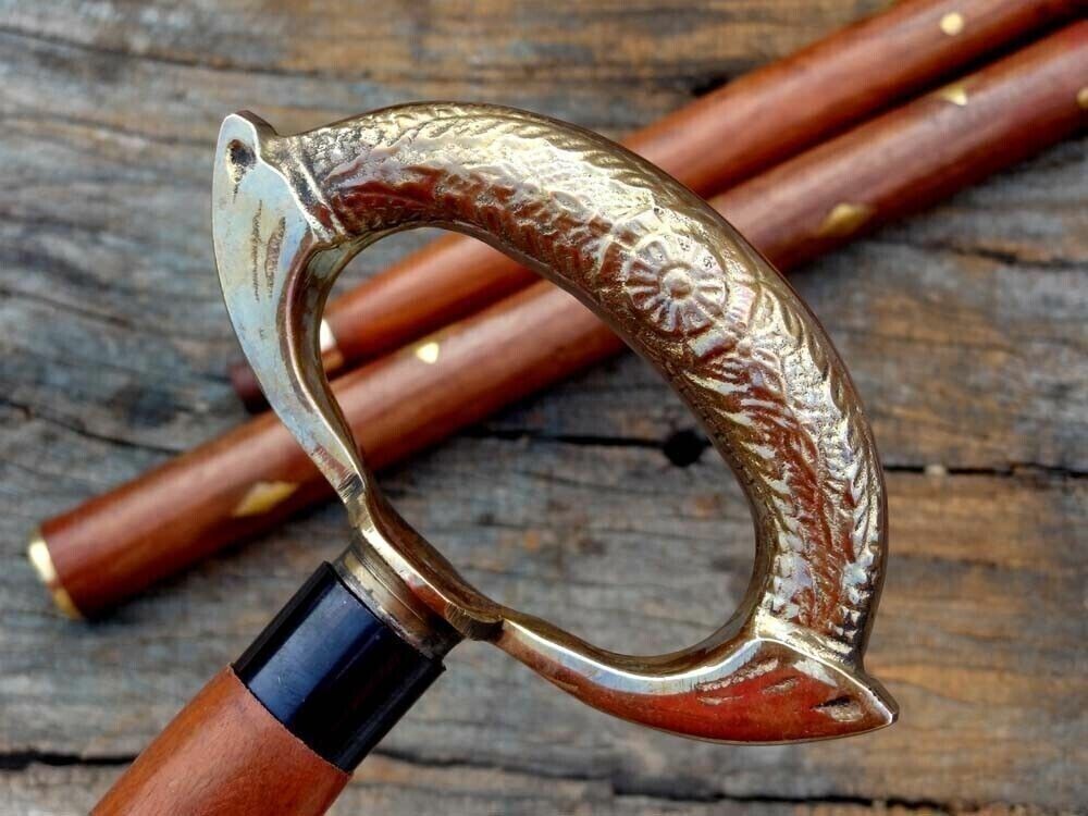Elegant brown wooden walking stick cane with brass ring and nautical style design, combining beauty and functionality.