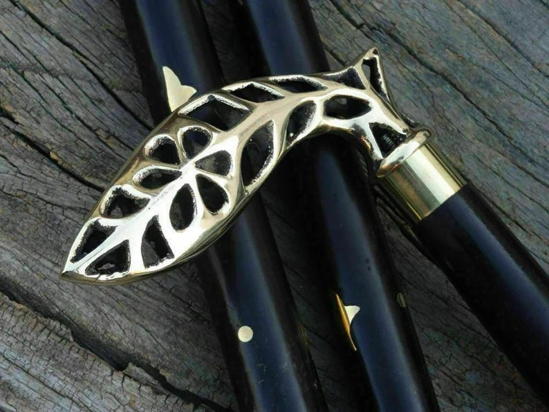 Close-up of the handmade Nautical Cane Wooden Walking Stick, emphasizing the intricate brass detailing on the handle.
