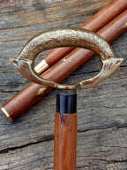 Removable brass ring between the handle and shaft of a vintage nautical walking stick cane.