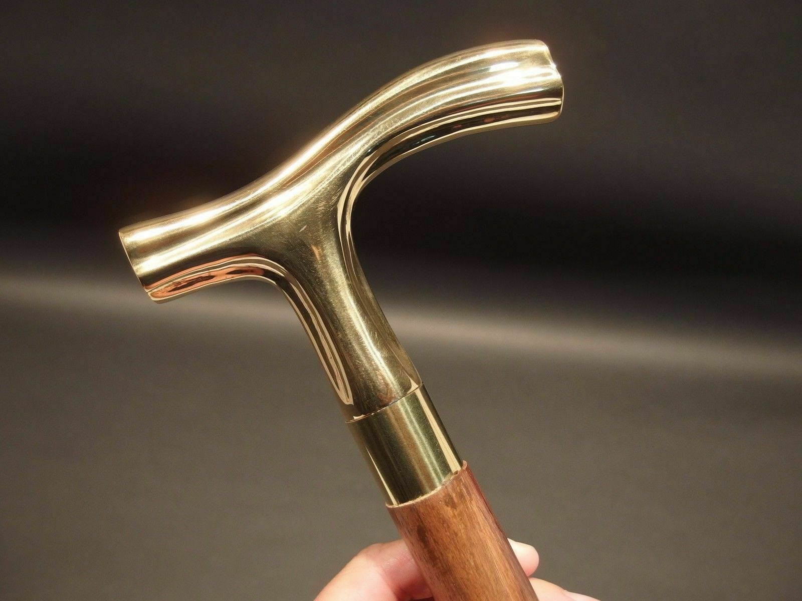 Removable brass ring between the handle and wooden shaft of the vintage walking stick cane, featuring an antique brass finish for added style.