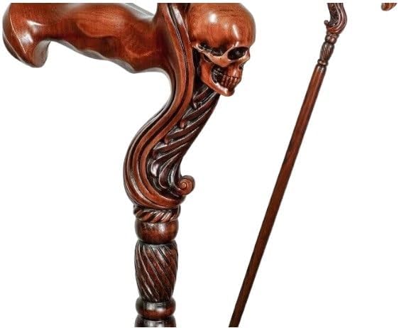 Close-up of the skull-shaped handle on a wooden walking cane, showcasing detailed craftsmanship.