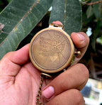 Close-up of solid brass engraved compass in antique finish with vintage design and personalized engraving.