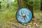 Blue Viking shield worn by a cosplayer, perfect accessory for historical role-playing and Viking reenactments.