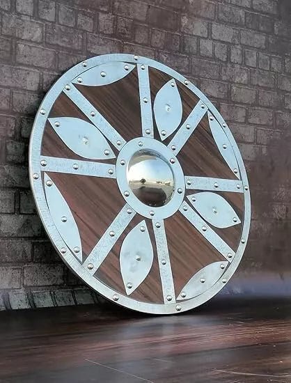 Battle-worn Viking shield used as a stunning medieval decor piece for home or office, adding historical charm.