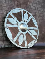 Battle-worn Viking shield used as a stunning medieval decor piece for home or office, adding historical charm.