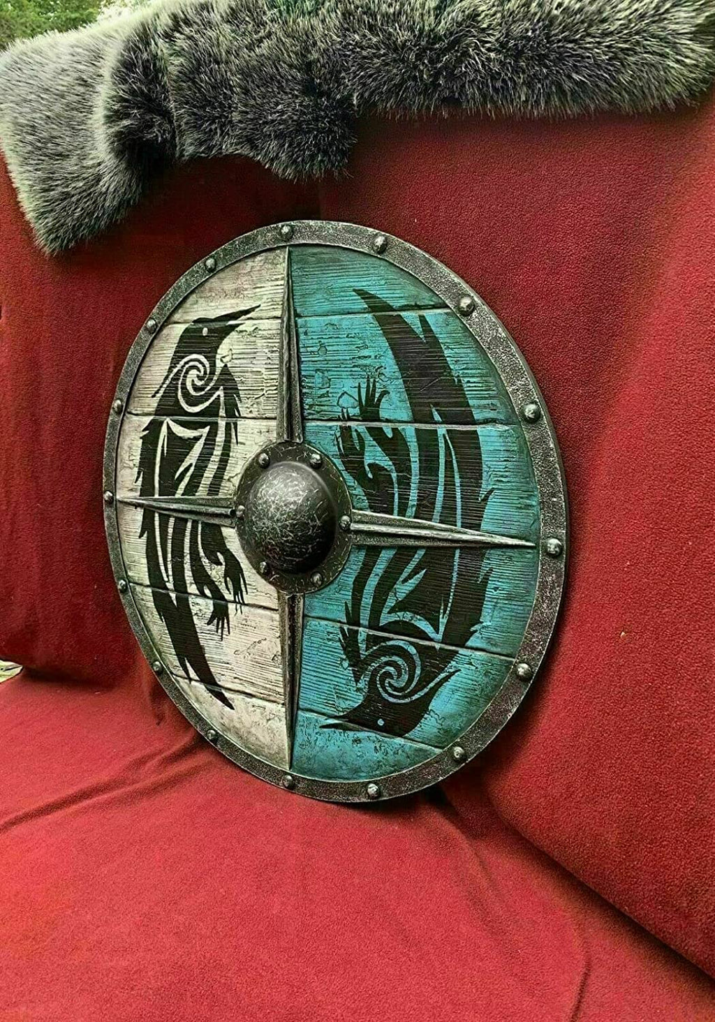 Round Viking shield crafted from wood and steel, ideal for home decor and historical enthusiasts