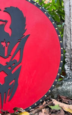 Authentic Viking wooden shield with a battle-worn finish, perfect for historical reenactments.