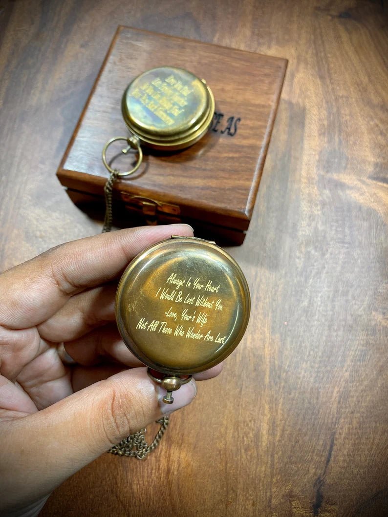 Antique-style brass pocket compass with a protective wooden case, ideal for collectors and adventurers.