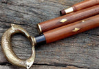 Vintage nautical brown wooden walking stick with removable brass ring between handle and shaft.